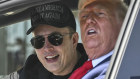 Trump and Musk speak to reporters as they sit in the Tesla Model S.