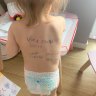 Name, phone, address: Spelling out survival on a toddler’s back