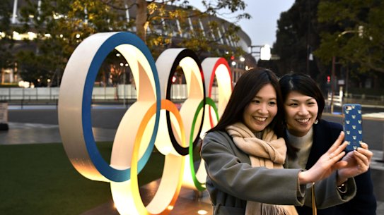 A selfie in front of the Tokyo Olympic rings near the new National Stadium in Tokyo.
