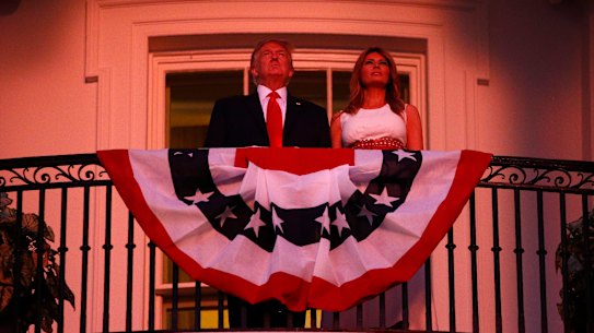 President Donald Trump and first lady Melania Trump stand on the Truman Balcony of the White House as they watch a fireworks display during a "Salute to America" event on July 4.