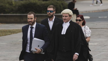 Alister Spong (second from left), joined by his wife, solicitor Jacob Robertson (left) and barrister Steven Whybrow (right)  arrives at the ACT Supreme Court for the trial over his friend's death at Summernats.