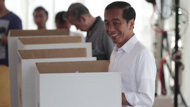 Indonesian President Joko "Jokowi" Widodo smiles as he votes in Jakarta on Wednesday.