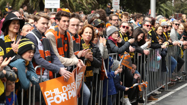 Spectators watch the 2019 AFL Grand Final Parade on September 27, 2019 in Melbourne, Australia.