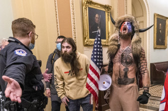 Jake Angeli, on the right, known as the Q Shaman, quickly became the face of the Capitol riots, striking poses even on the dais of the senate.  On September 3, Angeli pleaded guilty to a single count of obstructing a congressional proceeding and was sentenced to 41 to 51 months in prison.