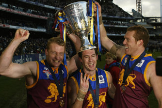 Craig McRae (centre) with Michael Voss and Justin Leppitsch after the Brisbane Lions’ third premiership in a row in 2003.