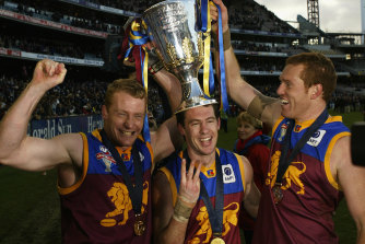 Craig McRae (centre) with Michael Voss and Justin Leppitsch after the Brisbane Lions’ third premiership in 2004.