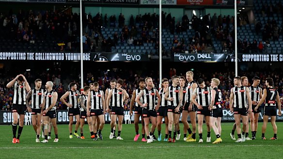 The Magpies look dejected after their loss to the Brisbane Lions.