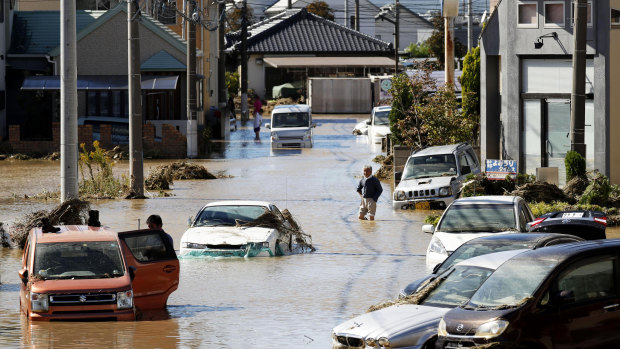 Vehicles are seen in mud water as Typhoon Hagibis hit the city in Sano, Tochigi prefecture.