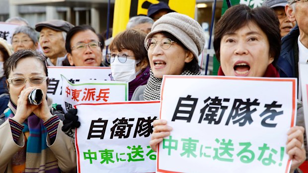 Protesters hold placards reading "Do not send Japan's Self-Defence Forces to Middle East" outside the prime minister's official residence in Tokyo on Friday.