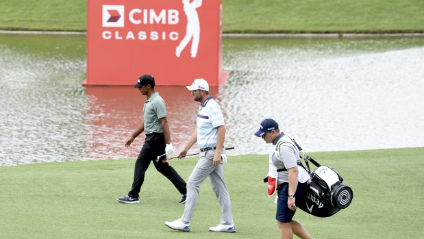 Walk in the park: The 34-year-old Australian from Warrnambool (centre) shot into the lead with four birdies in the first five holes on day two.