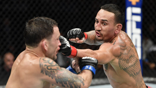 Max Holloway takes to Frankie Edgar during their UFC featherweight championship bout in July.