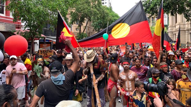 The Invasion Day protest moves through the Brisbane CBD last year.