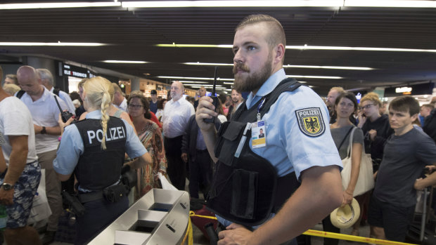 Police guard the hall of Terminal 1 after a family that tested positive for explosives were allowed to leave a secure area.