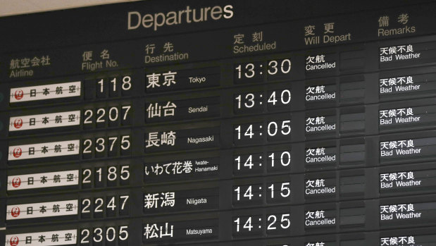A flight information board shows the cancellation of flights at Osaka airport, on Tuesday.