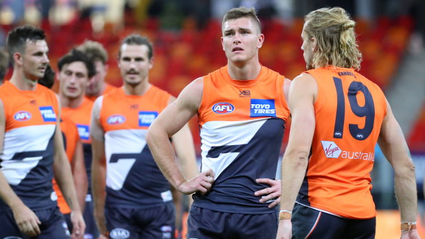 Giant flop: GWS players ponder their 61-point spanking.