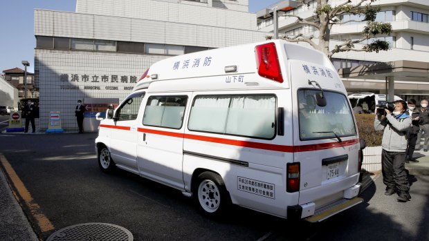 An ambulance carrying a passenger from the Diamond Princess cruise ship arrives at a hospital in Yokohama, near Tokyo.