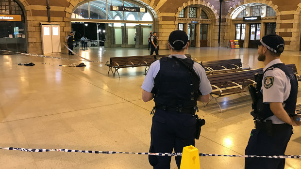 Police officers are seen at the scene where a police officer was stabbed in the back at Central Station.