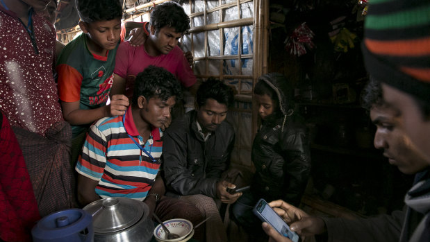 Rohingya refugees watch ICJ proceedings in a refugee camp in Cox's Bazar, Bangladesh. 