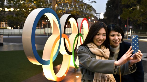 A selfie in front of the Tokyo Olympic rings near the new National Stadium in Tokyo.
