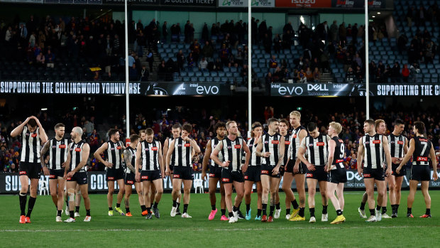 The Magpies look dejected after their loss to the Brisbane Lions.