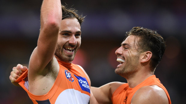 Running riot: Jeremy Finlayson, left, celebrates kicking a major with Stephen Coniglio.