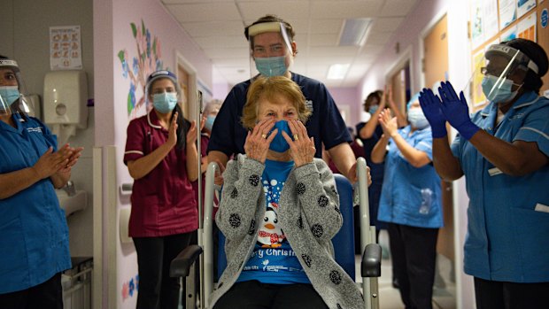 Margaret Keenan is applauded by staff as she returns to her ward after becoming the first person in the United Kingdom to receive the Pfizer/BioNtech vaccine.