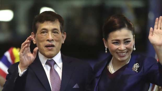 Thai King Maha Vajiralongkorn and Queen Suthida wave to supporters. Stringent defamation laws prohibit criticism of the royal family.