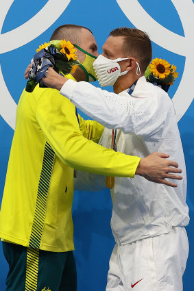 Kyle Chalmers and Caeleb Dressel embrace after the medal ceremony.