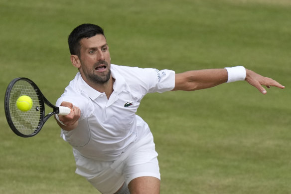 Djokovic stretches for a forehand.