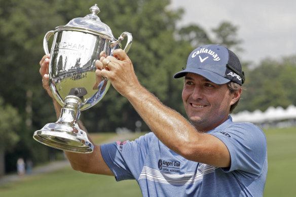 Kevin Kisner hoists the trophy at Sedgefield Country Club after winning a six-man play-off. 