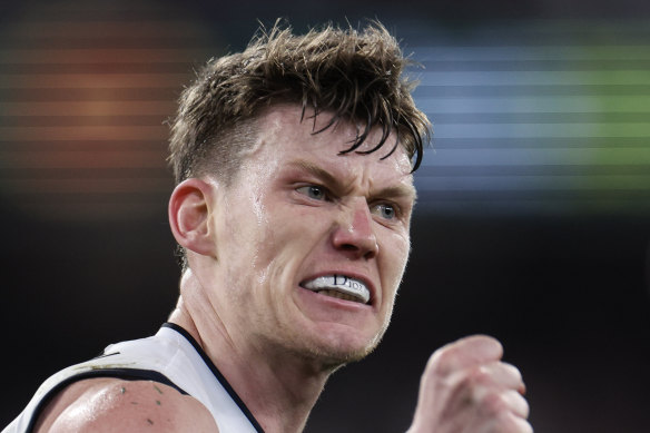 Sam Walsh flashes his “Dior” mouthguard after kicking a goal against the Demons.