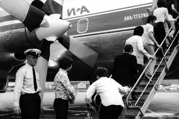 Chastened members of The Who and Small Faces board their plane for Sydney under the stern eye of an airport policeman.