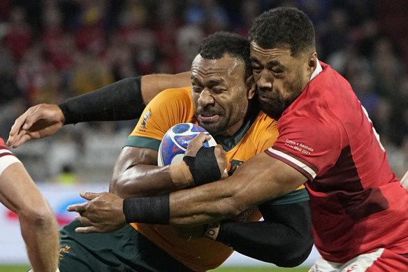 Australia’s Samu Kerevi is tackled by Wales’ Taulupe Faletau.