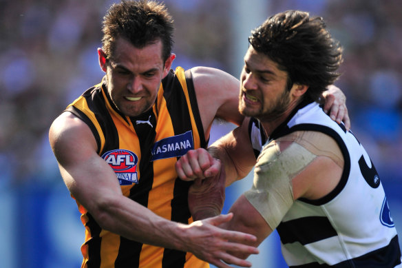 Geelong’s Max Rooke, a two-time premiership player with the Cats, battles for the ball with Hawthorn skipper Luke Hodge.