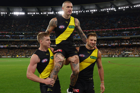 Dustin Martin of the Tigers is carried from the ground following his 300th match.