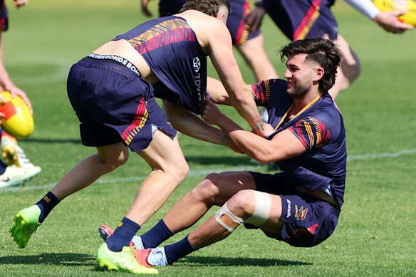Josh Rachele (left) hams it up with teammate Jake Soligo at training on Thursday.