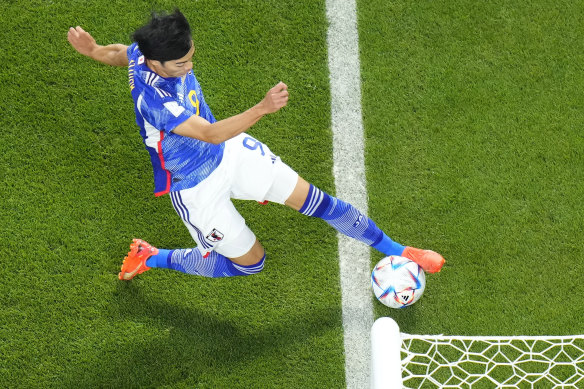 Japan’s Kaoru Mitoma appears to have the ball over the line before crossing it for a goal,