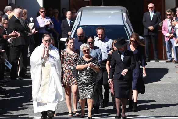 Tommy Raudonikis’ wife Trish Brown leads the procession during the funeral for the rugby league great at Sacred Heart Catholic Church on the Gold Coast on Friday. 