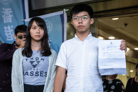Joshua Wong with fellow Demosisto member Agnes Chow, left, after they were granted bail in August.