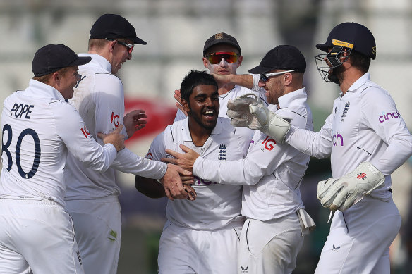 Rehan Ahmed is congratulated after taking the wicket of Mohammad Rizwan in Karachi.