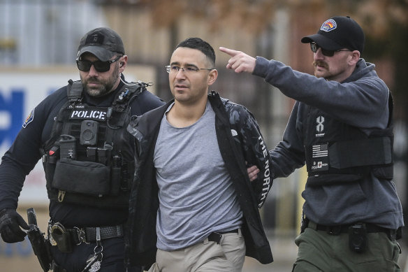 Solomon Pena, a former Republican candidate for New Mexico House District 14, is taken into custody by Albuquerque police officers,