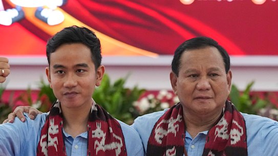 Presidential candidate Prabowo Subianto (right) and his running mate Gibran Rakabuming Raka, the eldest son of President Joko Widodo, wave at the media after registering their candidacy in Jakarta on Wednesday.