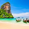 Traditional boats, beaches and a limestone cliff for a quintessential tropical Thai setting.