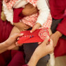 “Hong bao” or red packets are given by adults to children as a Lunar New Year tradition.