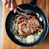 Stock image of a steak being cooked
