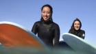 Samichhya Khadka (left), Stephanie Willis (centre) and Lucy Byrne, here at Maroubra on Sunday, were part of the nearly 120,000 women who took up surfing during the COVID-19 pandemic.