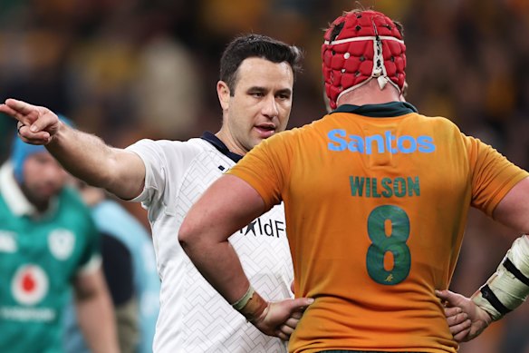 Referee Ben O’Keeffe speaks to Harry Wilson.