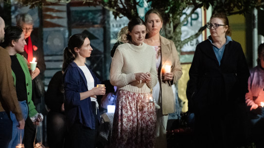 Sophie Roome is comforted by family, friends and the community of Lismore at a silent vigil for Rowan, 2, who was murdered by his father last Sunday.