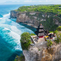 On which island can you visit Pura Luhur Uluwatu temple?