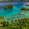Overwater bungalows along the coast of the Raja Ampat Islands.